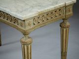 an image of a marble topped table with ornate carvings on the top