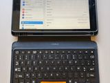 a tablet computer sitting next to a laptop computer on a table