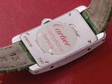 a close up of a wrist watch on a red surface