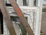 a pile of old windows and a ladder on a pallet