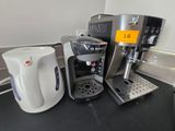 a coffee maker and a coffee cup on a counter
