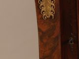 a small wooden table with a clock on top of it
