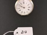 a small gold pocket watch with a price tag attached to it