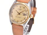 an image of a wrist watch with a gold dial and brown leather strap