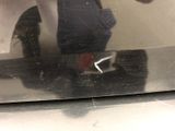 a reflection of a person in the mirror of a microwave