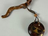 a small wooden object with a bird on it