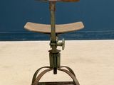 a wooden seat on top of a metal stool