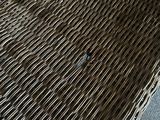 a wicker chair that is sitting on the floor