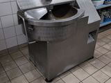 an image of a commercial kitchen with a large machine in it