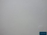 a close up of a white wall with a blue sign on it