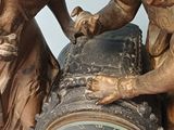 a statue of a boy and a girl with a clock