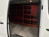 a white van that is open and has a bookcase in the back