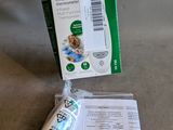 a package of medicine and a toothbrush sitting on a couch