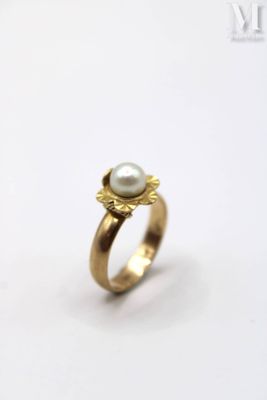 an image of a gold ring with a pearl in the center