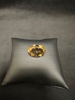 a close up of a cushion with a yellow diamond on it