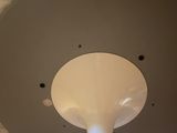 a ceiling light that is in a room with marble walls