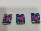 three pieces of blue and pink electronics sitting on top of a white table