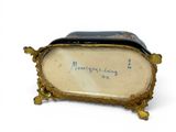 a gold frame with a picture of a woman on it