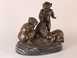 bronze statue of a boy and two boys playing with a dog