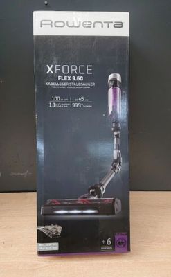 a box of a vacuum cleaner sitting on top of a wooden table