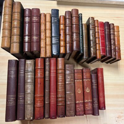a lot of books that are stacked up on a shelf