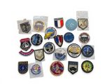 a lot of different military patches on a white surface
