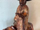 statue of a man riding a horse with a hat on top of it
