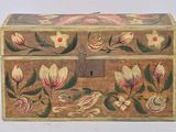 a small wooden box with a floral design on it