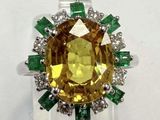 a close up of a yellow and green ring on a white surface