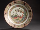 a plate with a bird on it on a stand