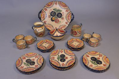 many pieces of pottery that are sitting on a table