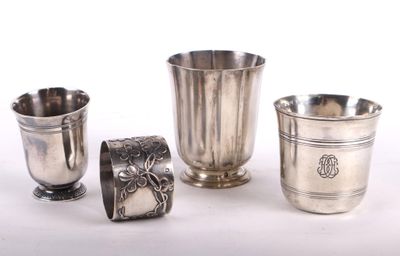 three silver cups and a silver cup on a white surface