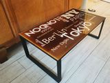 a coffee table with a sign on it on the floor