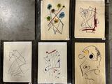 four paintings of different shapes and sizes are displayed on a wall