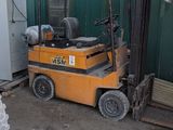 a forklift that is parked in front of a building