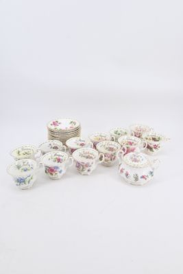 several cups and saucers are arranged on a white surface