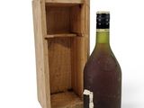 a bottle of wine sitting next to a wooden box