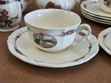 a lot of cups and saucers sitting on a table