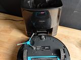 a black and blue robot sitting on a wooden table