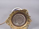 a silver and gold candle holder on a white table