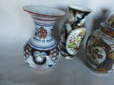 three vases sitting next to each other on a table