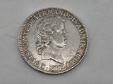 a close up of a coin on a white surface