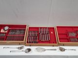 two trays with spoons and spoons in them on a table