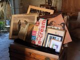 a wooden box filled with pictures and pictures on the floor