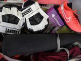 several pairs of tennis shoes are packed in a suitcase