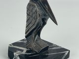 an image of a statue of a bird on a marble base