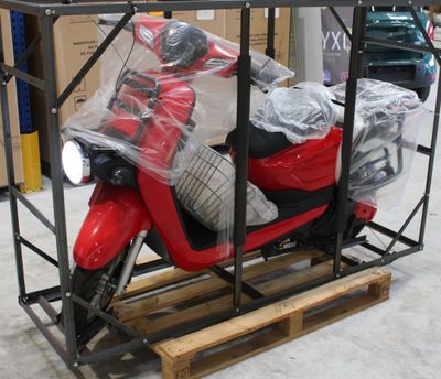 un scooter rouge posé sur une palette