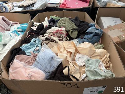 many boxes of clothes that are sitting on the ground