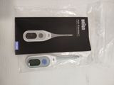 a digital thermometer sitting on a table next to a package