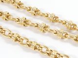 a close up of a gold chain on a white background